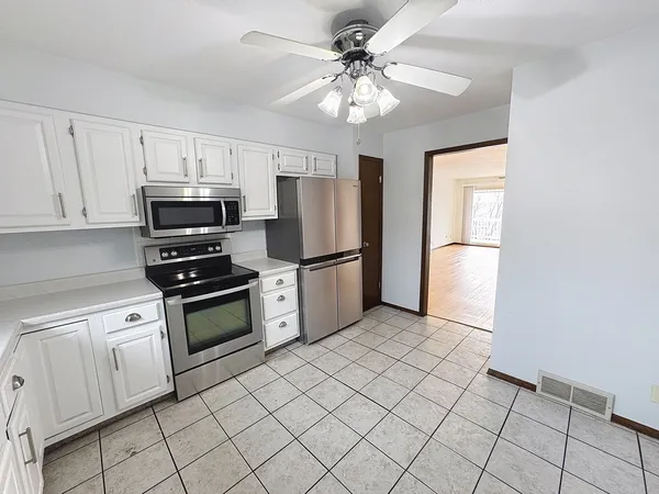 a kitchen with granite countertop a refrigerator and a sink