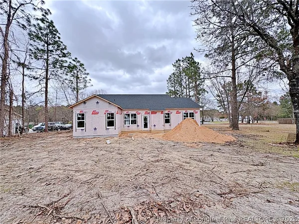 a view of a house with a yard covered in snow