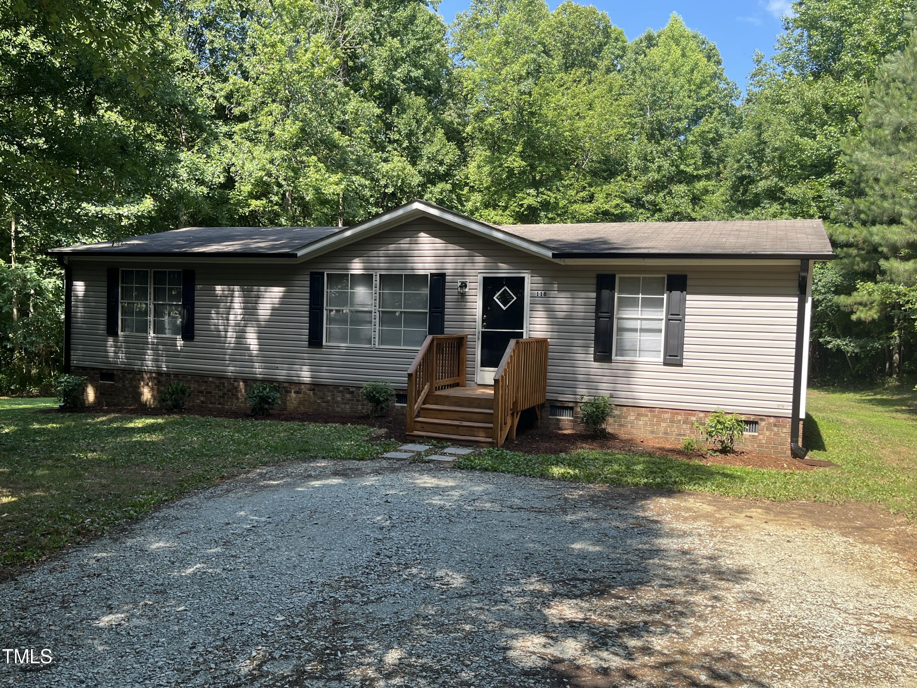 118 Portia Lane Roxboro, NC 27574 - Photo 1 of 16 a front view of a house with garden