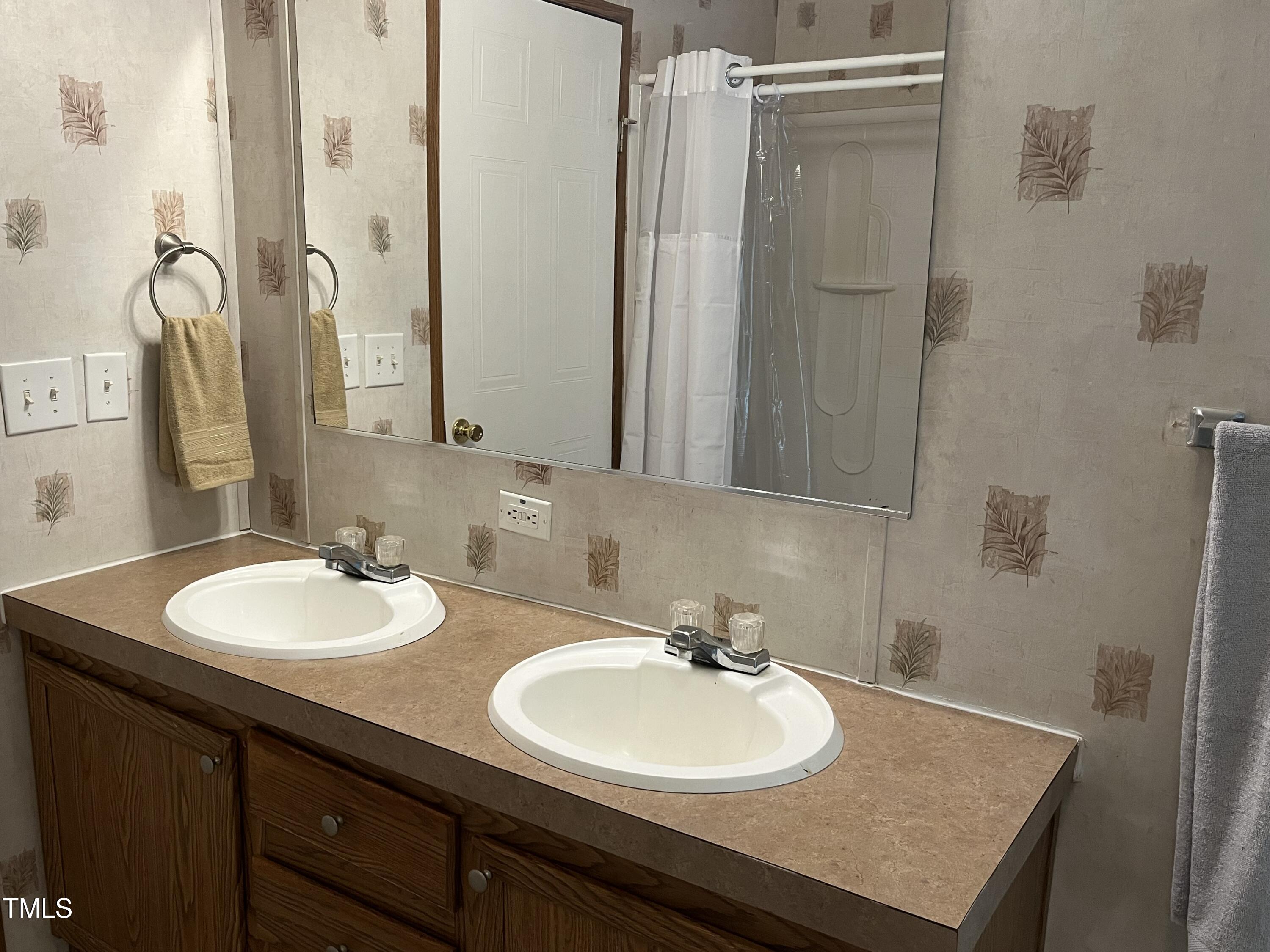 118 Portia Lane Roxboro, NC 27574 - Photo 11 of 16 a bathroom with a granite countertop sink and a mirror