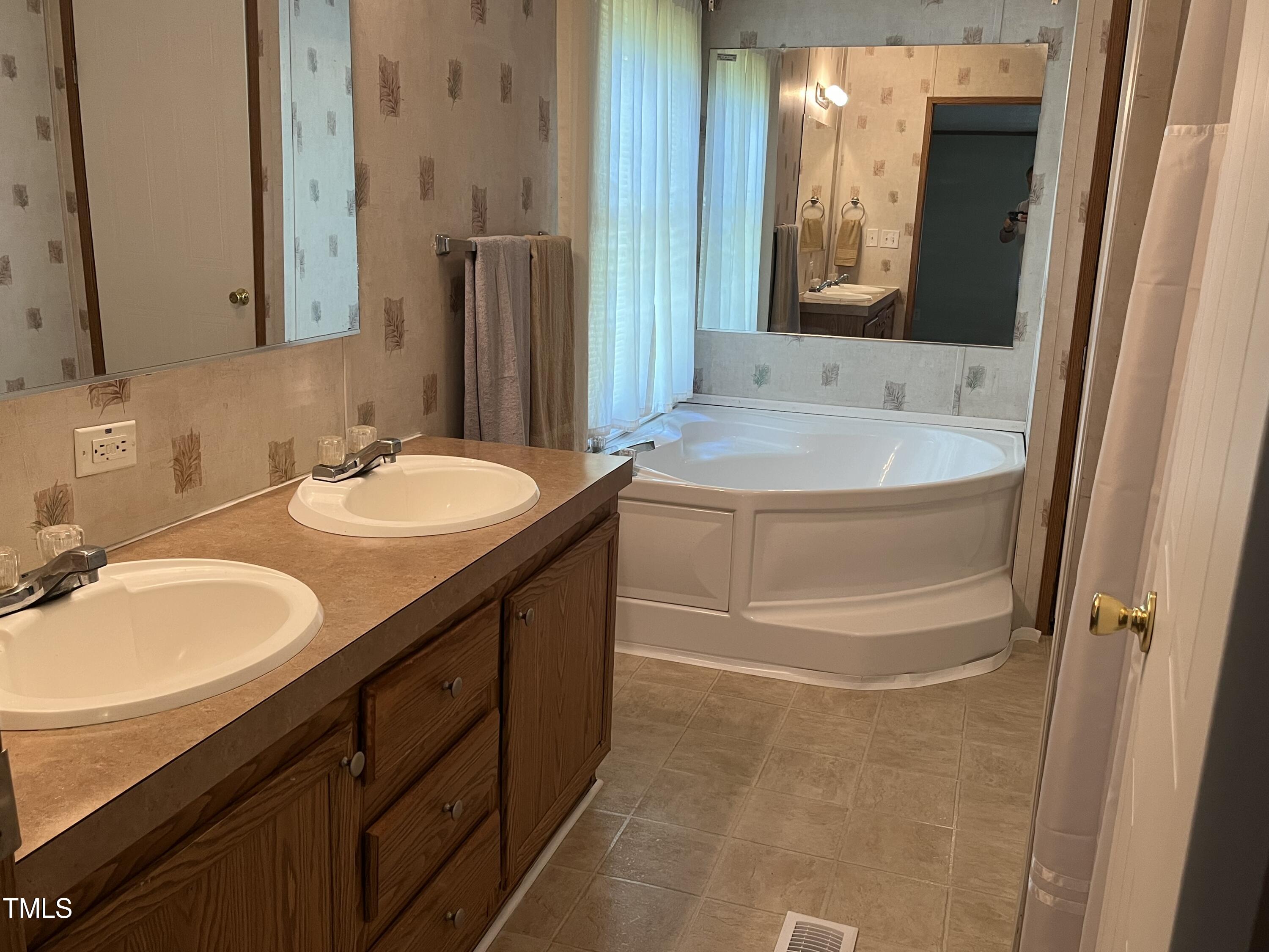 118 Portia Lane Roxboro, NC 27574 - Photo 12 of 16 a bathroom with a granite countertop sink and a mirror