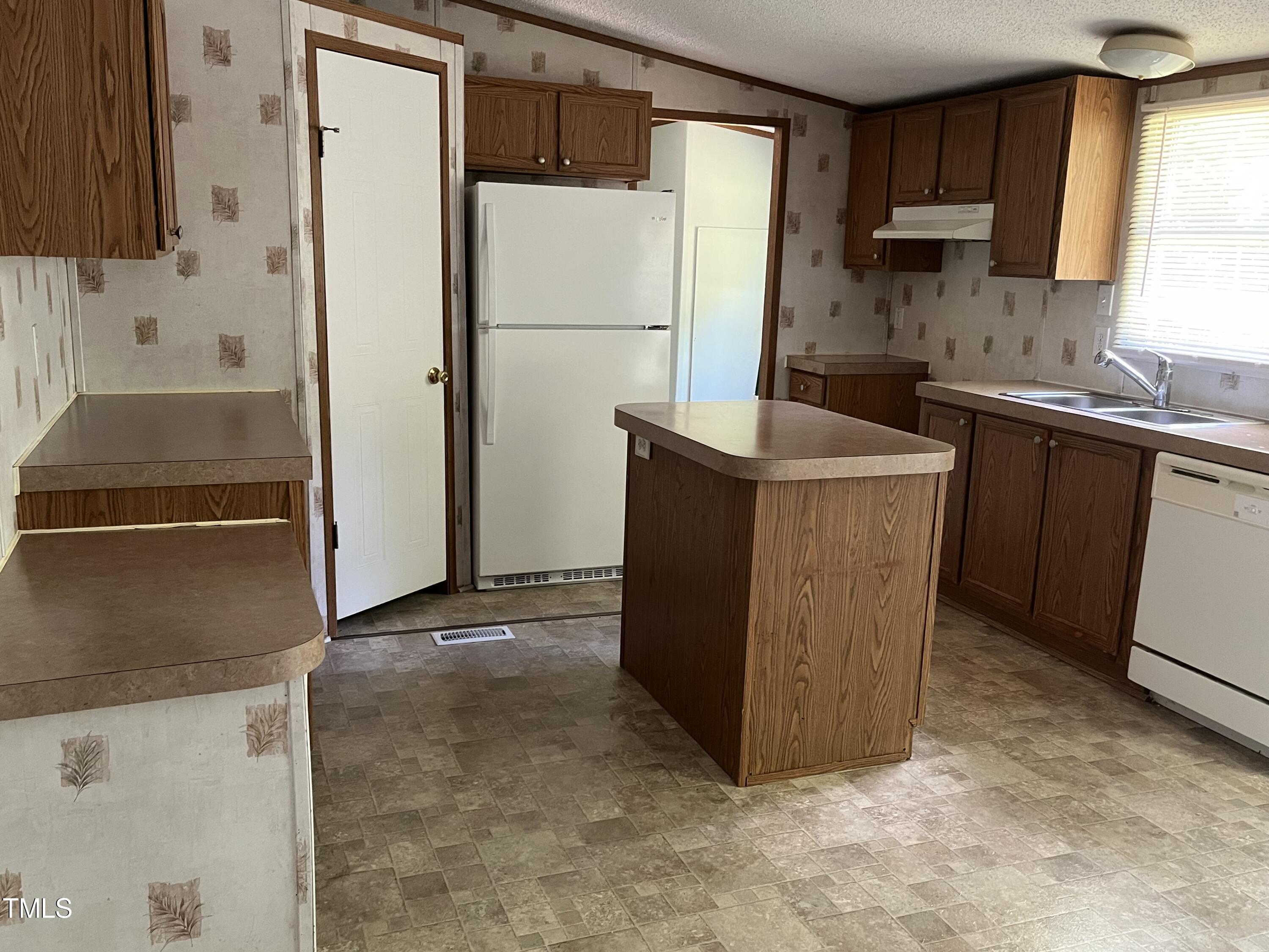 118 Portia Lane Roxboro, NC 27574 - Photo 6 of 16 a kitchen with a refrigerator sink and cabinets