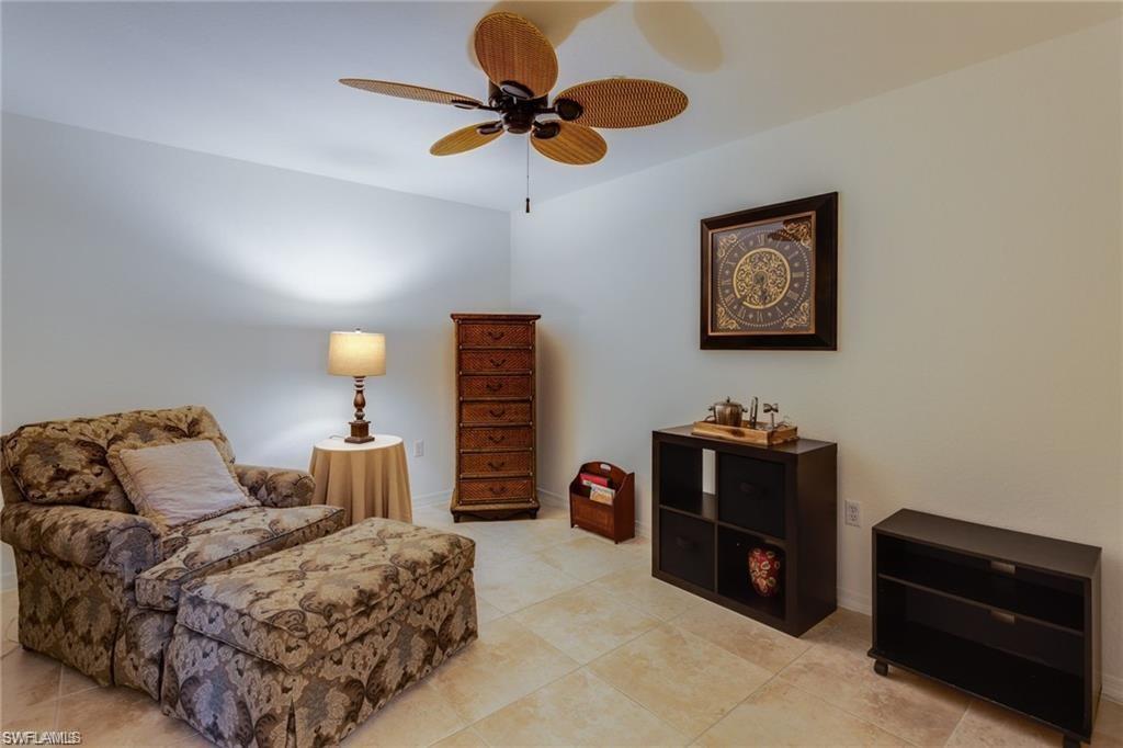 20201 Estero Gardens Circle, Unit 104 Estero, FL 33928 - Photo 13 of 38 a bedroom with bed and a chandelier