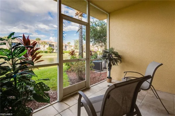 a view of a balcony with table and chairs