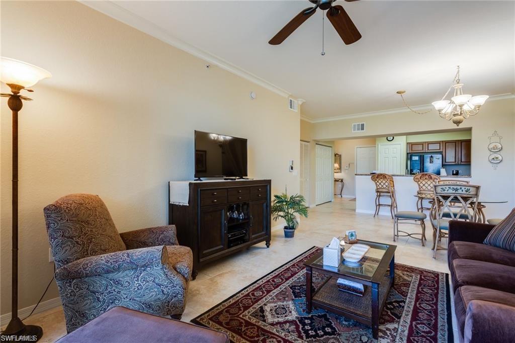 20201 Estero Gardens Circle, Unit 104 Estero, FL 33928 - Photo 9 of 38 a living room with furniture and a fireplace