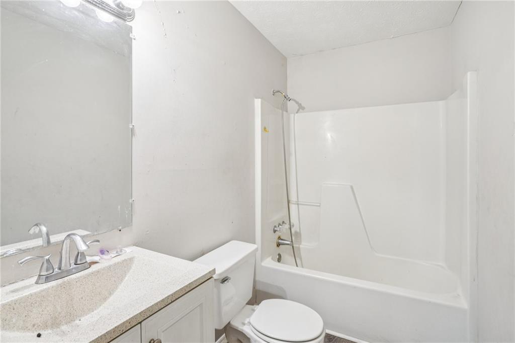 1608 Pine Tree Trail Atlanta, GA 30349 - Photo 11 of 17 a bathroom with a sink toilet and shower