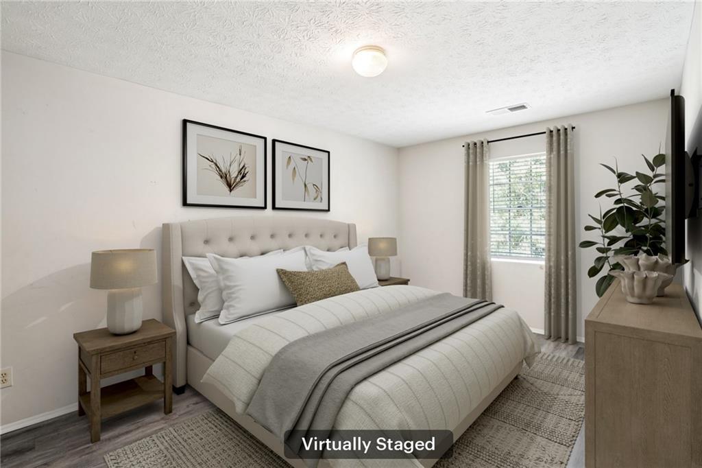 1608 Pine Tree Trail Atlanta, GA 30349 - Photo 8 of 17 a bed room with a bed and a potted plant