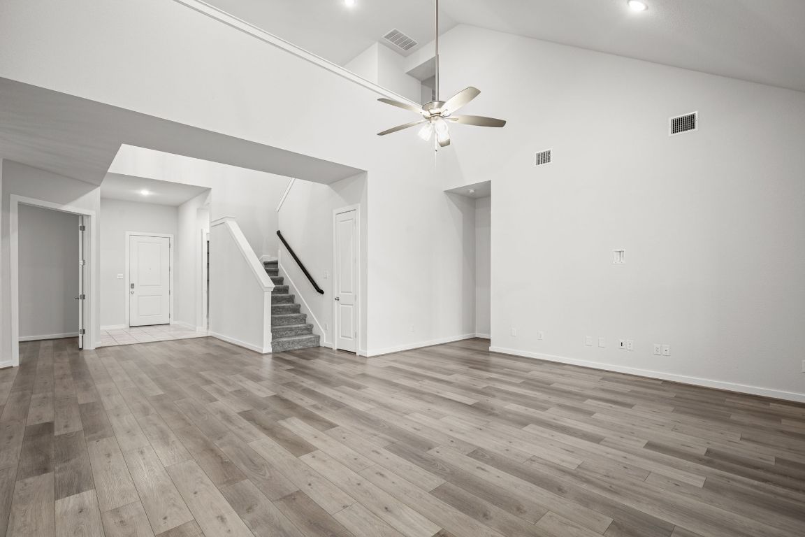 841 Spinnaker Loop Kyle, TX 78640 - Photo 11 of 40 wooden floor in an empty room with a chandelier fan
