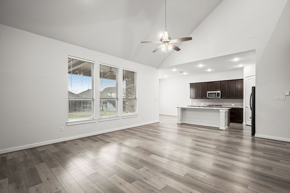 841 Spinnaker Loop Kyle, TX 78640 - Photo 12 of 40 a view of an empty room with kitchen and window