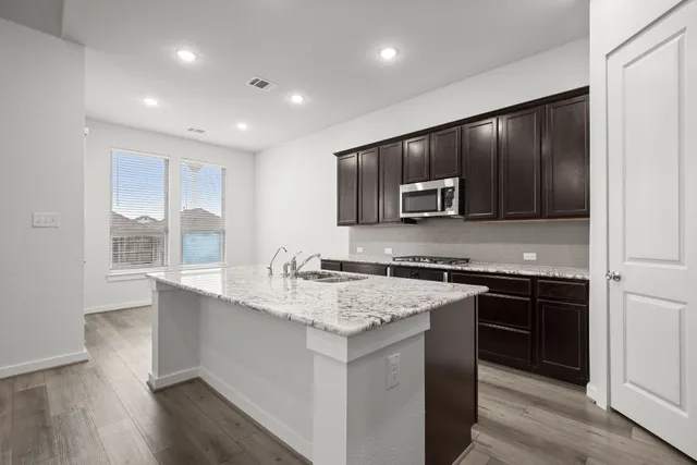 a view of kitchen with sink microwave and stove