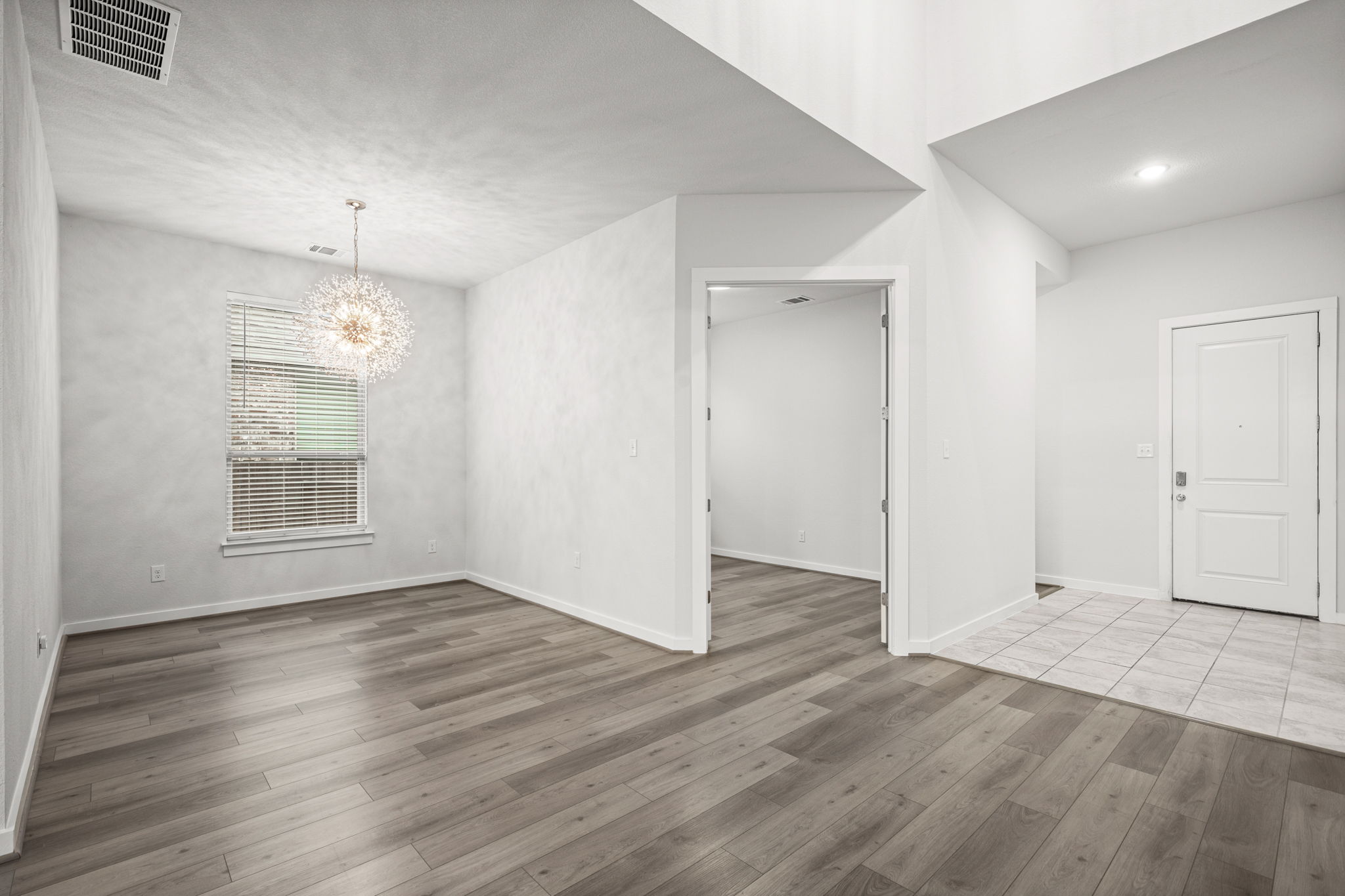 841 Spinnaker Loop Kyle, TX 78640 - Photo 11 of 40 an empty room with wooden floor and windows