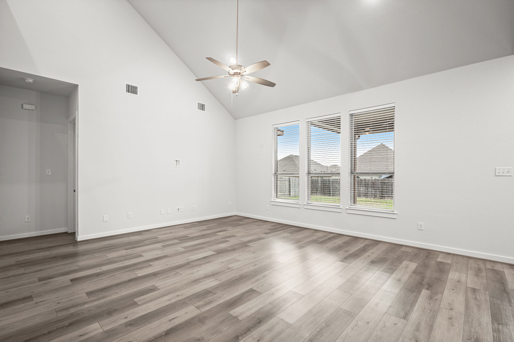 841 Spinnaker Loop Kyle, TX 78640 - Photo 13 of 40 a view of an empty room with wooden floor and a window