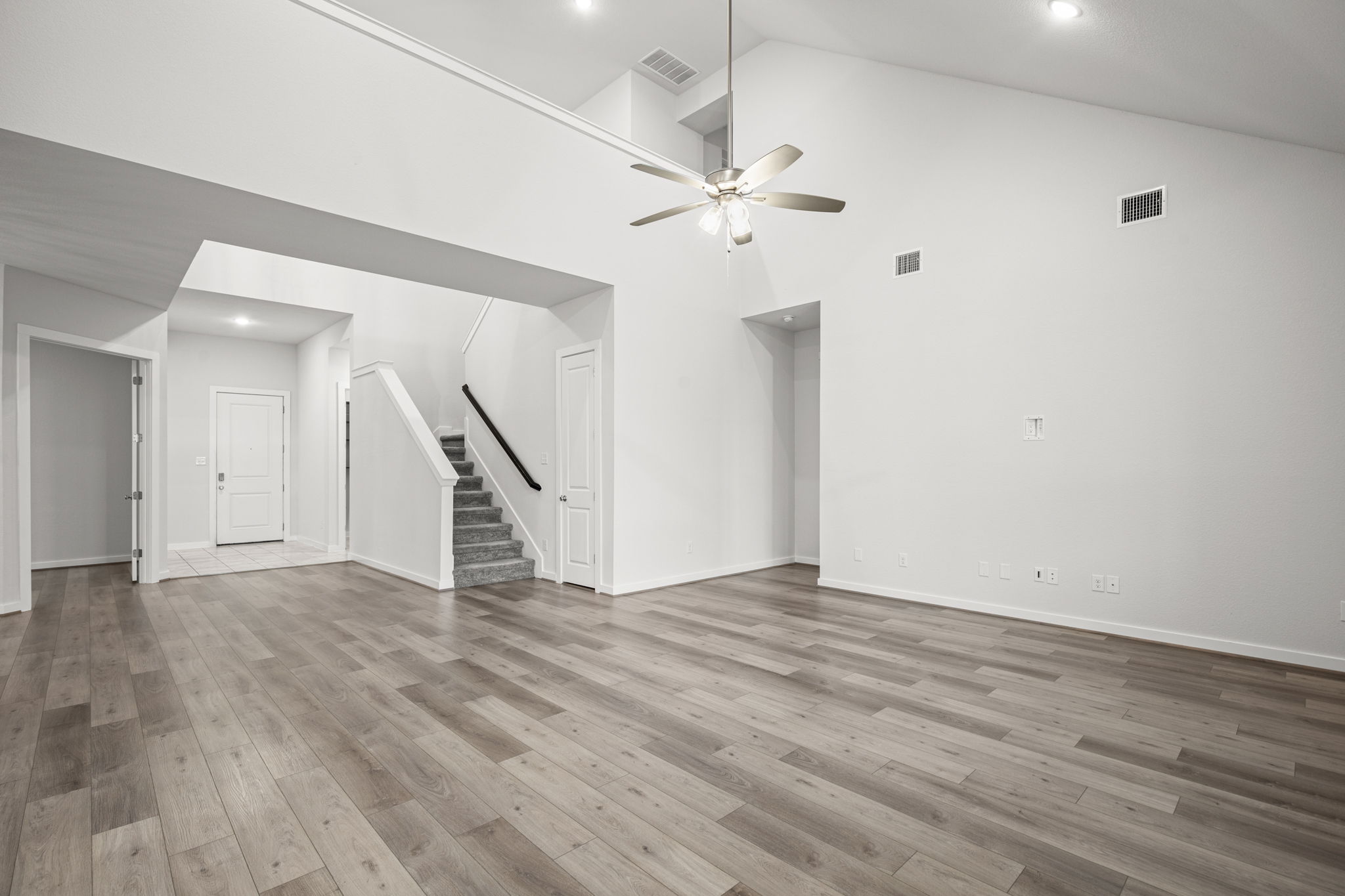 841 Spinnaker Loop Kyle, TX 78640 - Photo 14 of 40 wooden floor in an empty room with a chandelier fan