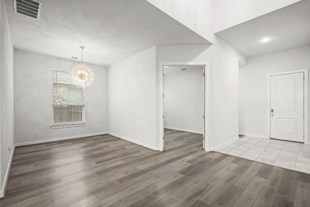 a kitchen with granite countertop kitchen island a sink appliances and a window