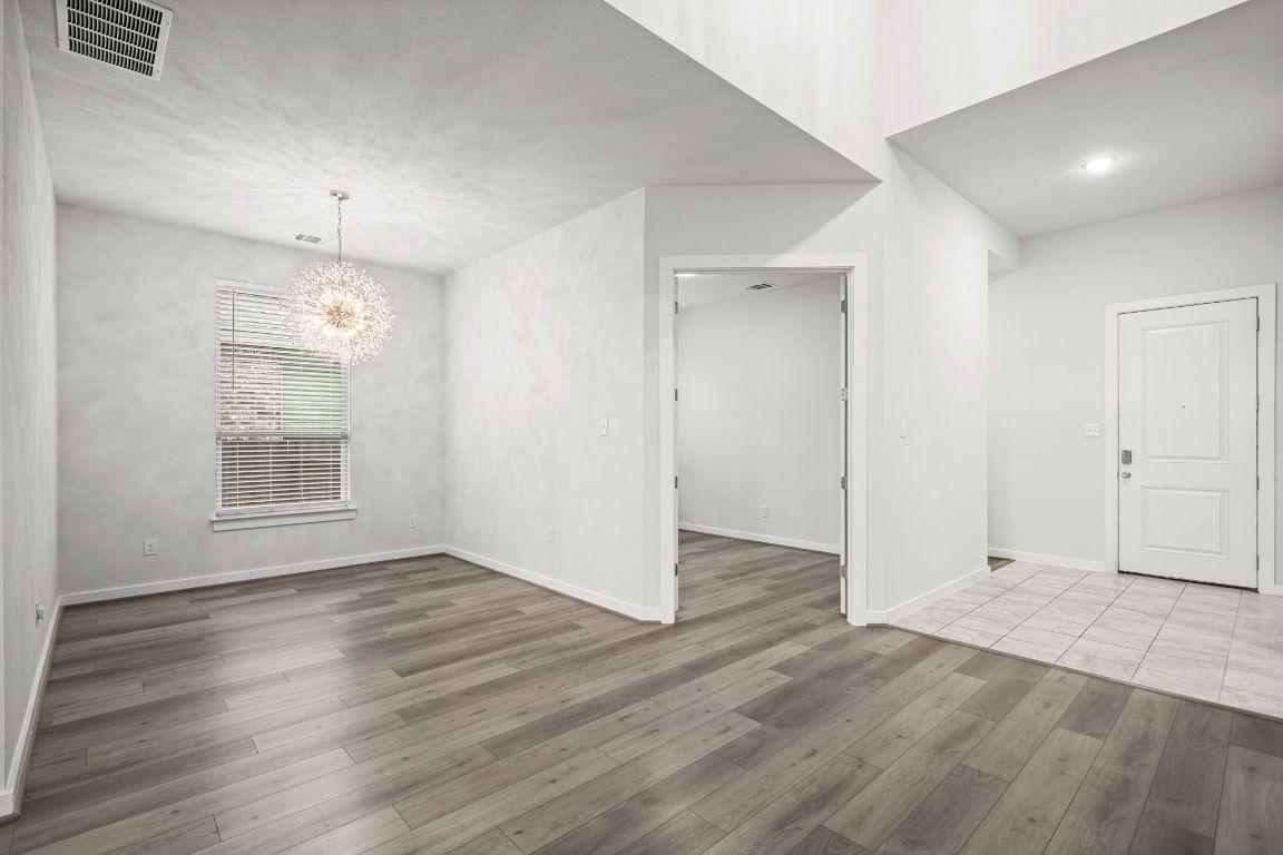 841 Spinnaker Loop Kyle, TX 78640 - Photo 17 of 40 an empty room with wooden floor and windows