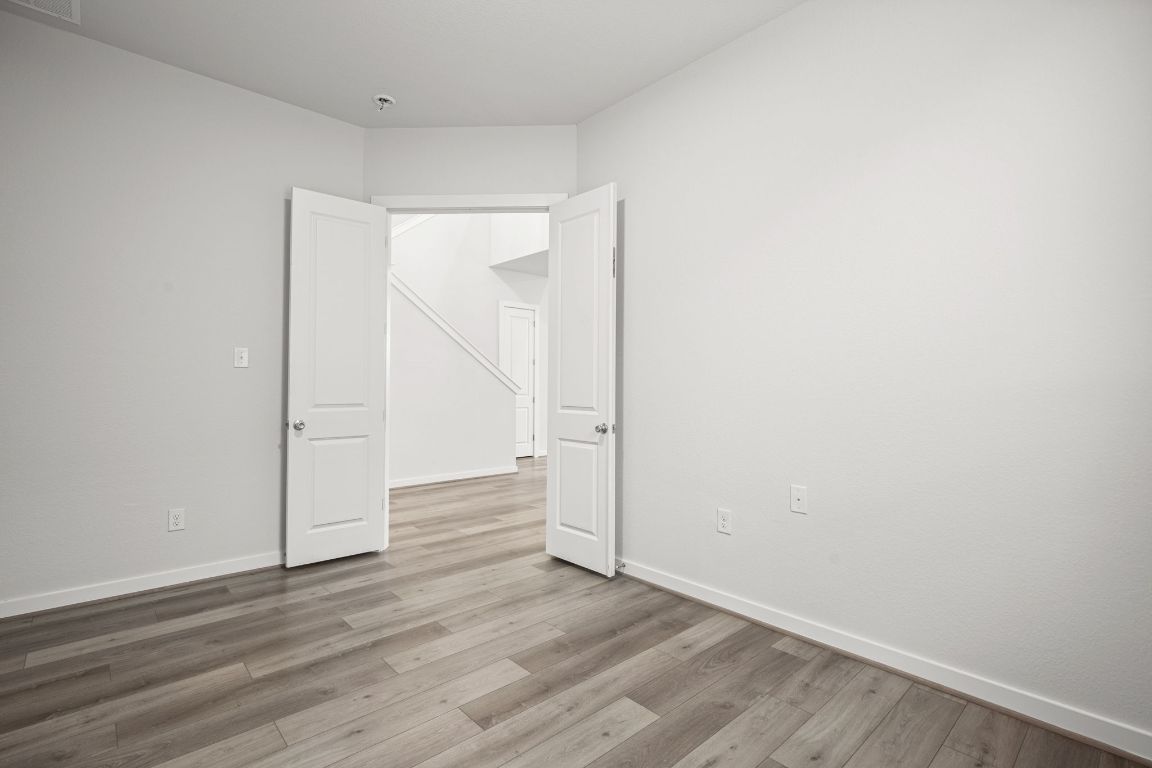841 Spinnaker Loop Kyle, TX 78640 - Photo 18 of 40 a view of an empty room with wooden floor