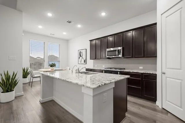a kitchen with a sink stove and microwave
