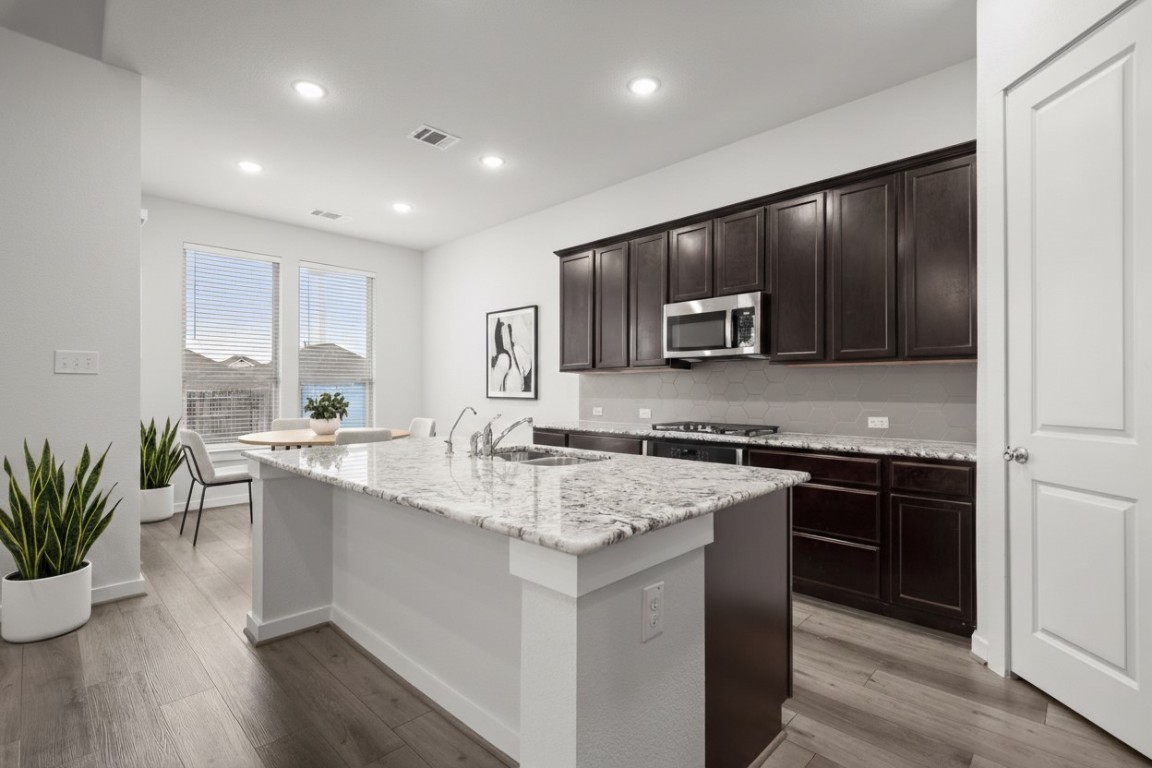 841 Spinnaker Loop Kyle, TX 78640 - Photo 2 of 40 a kitchen with a sink stove and microwave