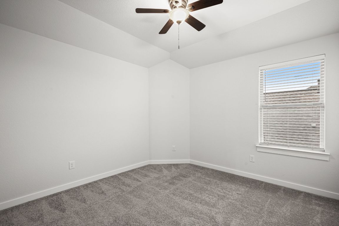 841 Spinnaker Loop Kyle, TX 78640 - Photo 29 of 40 an empty room with a window and a fan