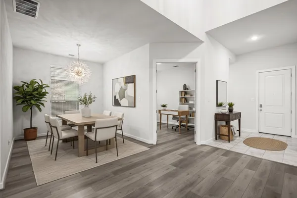a view of a dining room with furniture and wooden floor