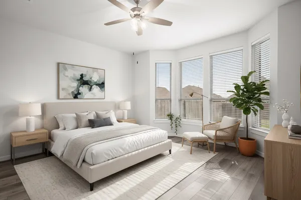 a bedroom with a large bed and a chandelier