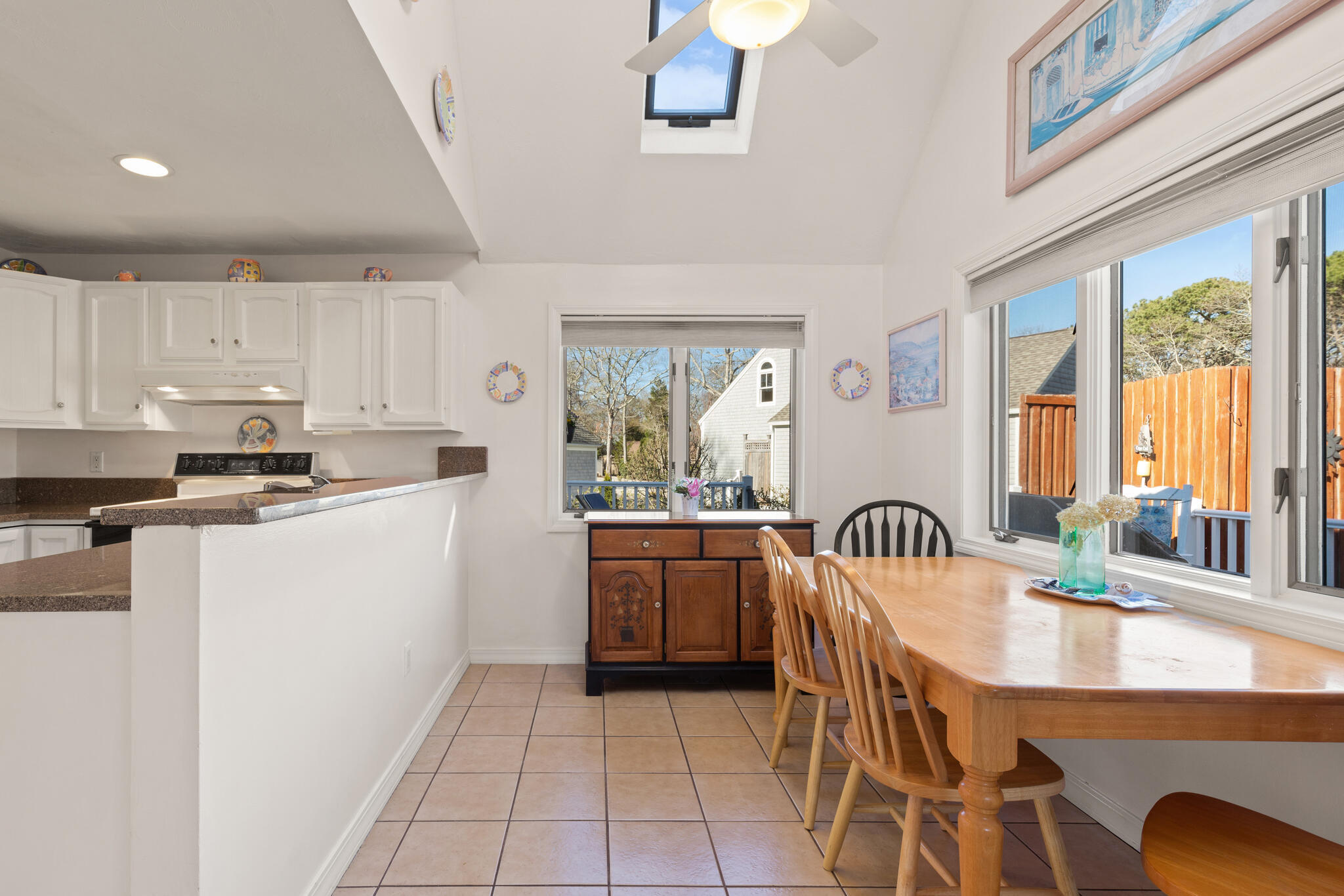 103 Summersea Road Mashpee, MA 02649 - Photo 12 of 41 a kitchen with a table chairs sink and cabinets