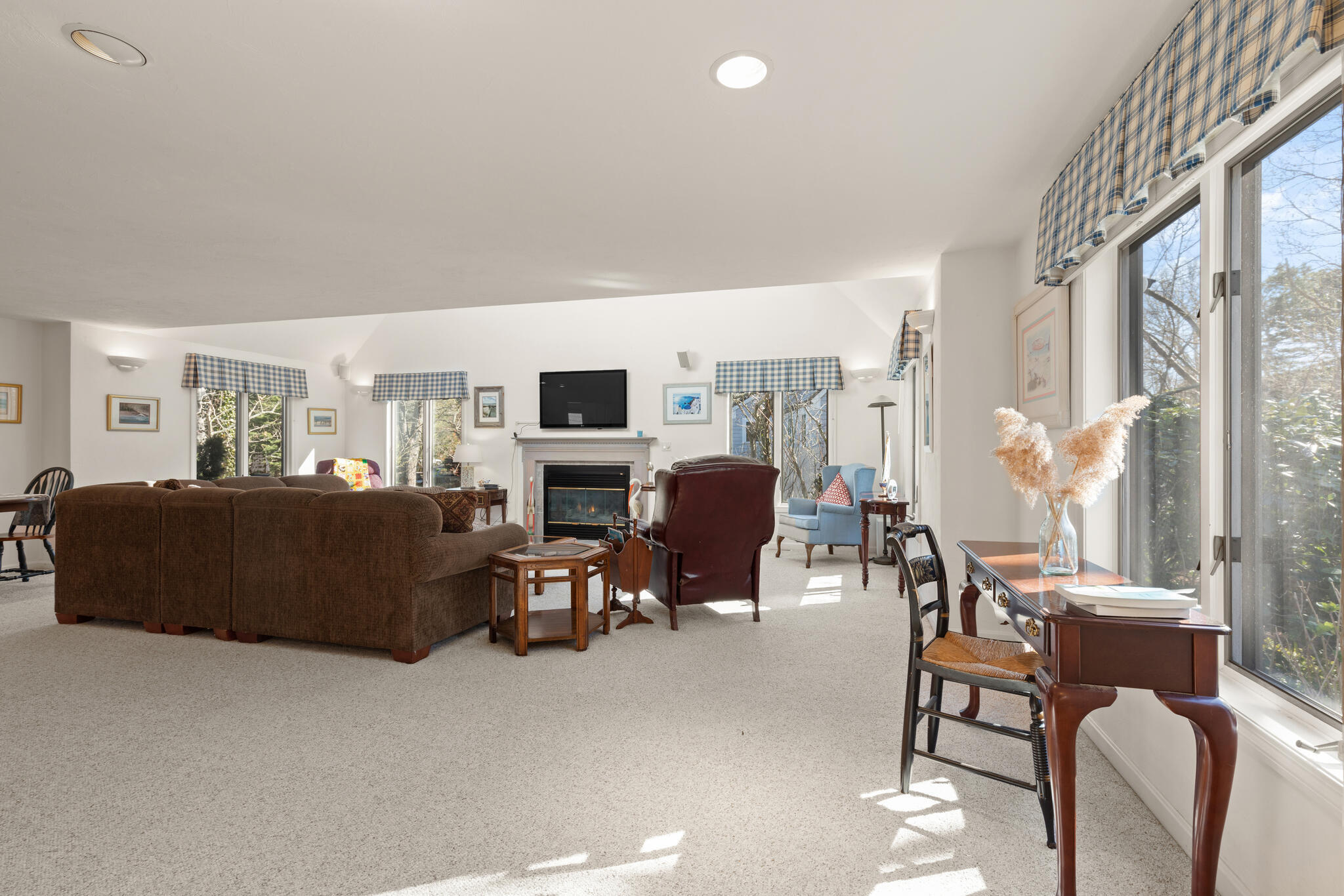 103 Summersea Road Mashpee, MA 02649 - Photo 7 of 41 a living room with furniture potted plant a fireplace and a large window