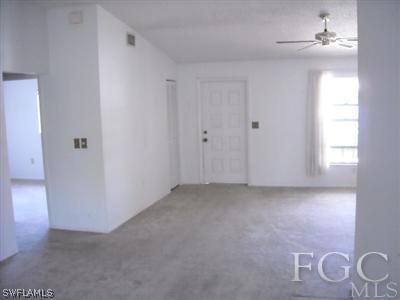 7484 Garry Road Fort Myers, FL 33967 - Photo 3 of 3 a view of a livingroom with a chandelier fan and windows