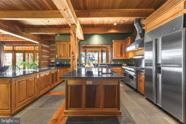 a dining room with furniture and a floor to ceiling window