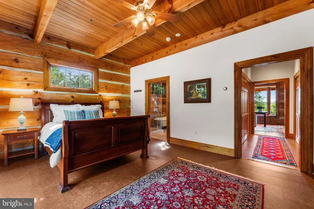 a spacious bedroom with a large bed and a window