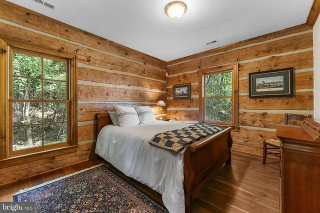 a view of a house with garden and a car park front of house