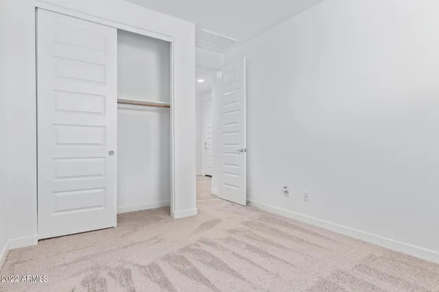 an empty room with closet area