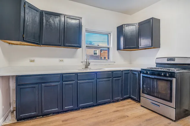 a kitchen with wooden cabinets and stainless steel appliances