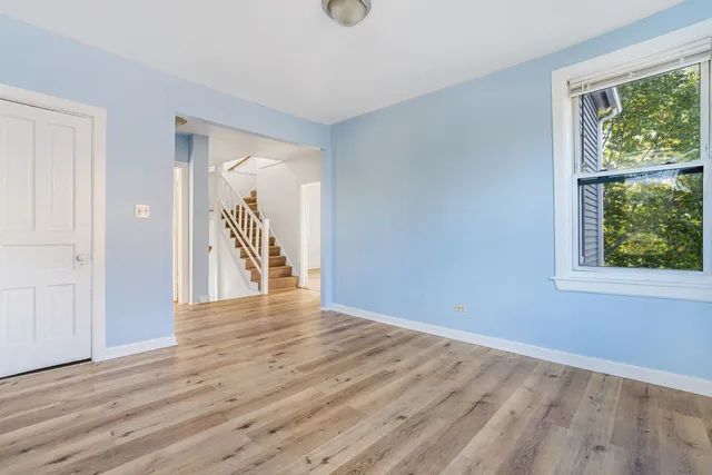 a view of a livingroom with wooden floor and a window