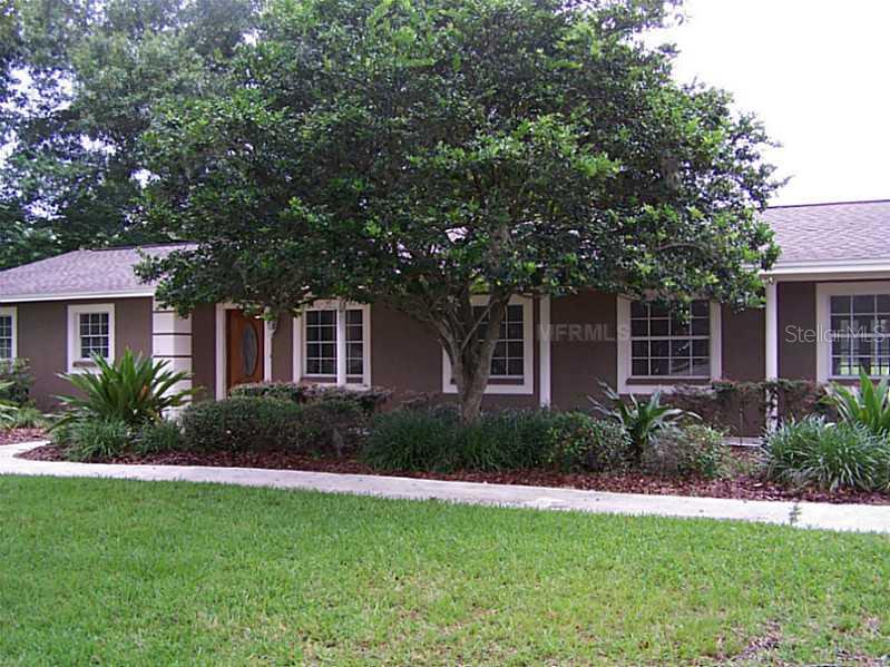 2020 North Dover Road Dover, FL 33527 - Photo 1 of 1 a front view of a house with a garden