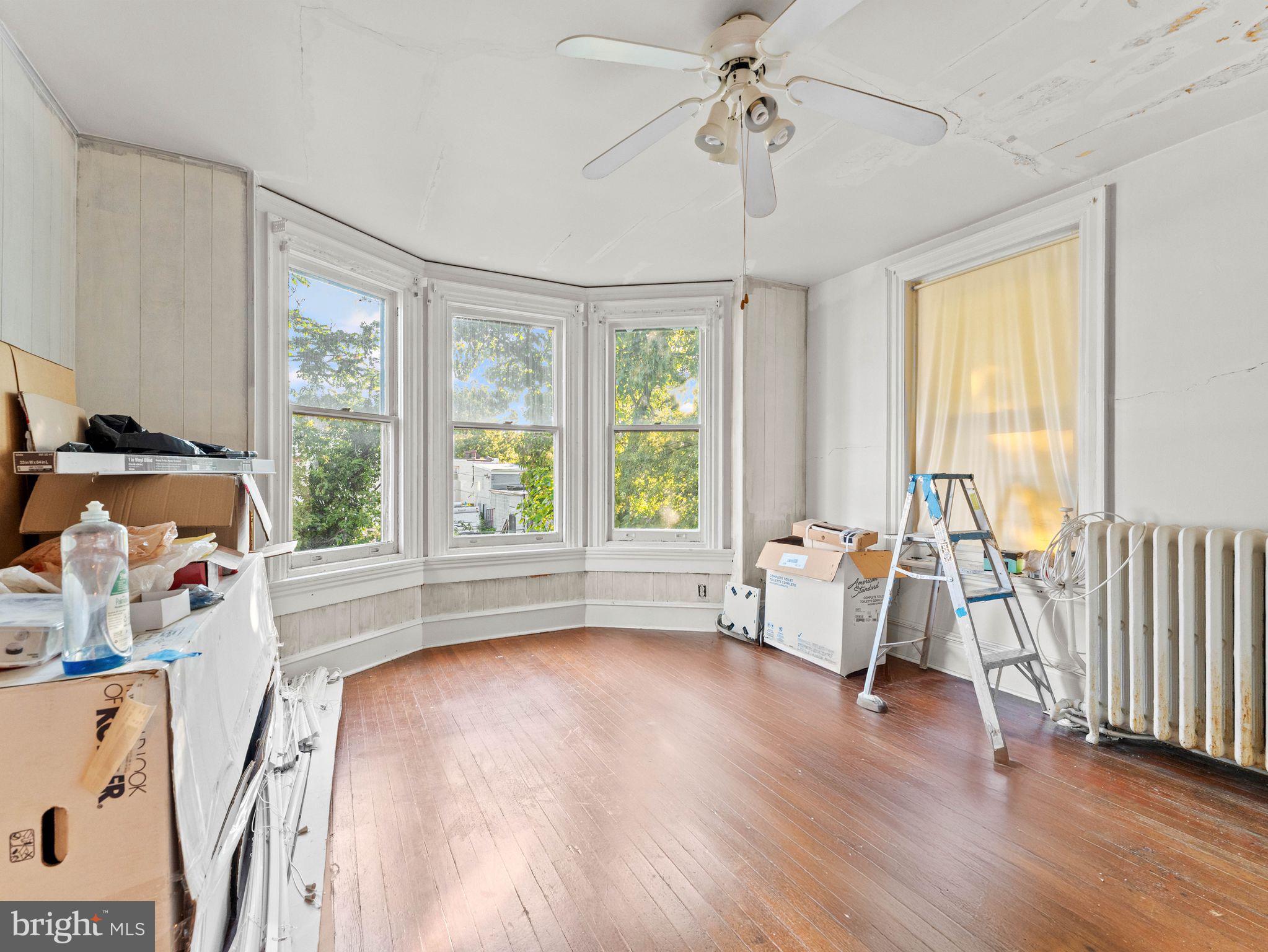 149 Herman Street Philadelphia, PA 19144 - Photo 11 of 35 a view of a livingroom with furniture hardwood floor a ceiling fan and windows