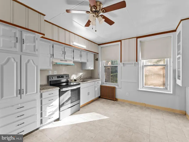 a kitchen with stainless steel appliances kitchen island granite countertop a stove a sink and a refrigerator