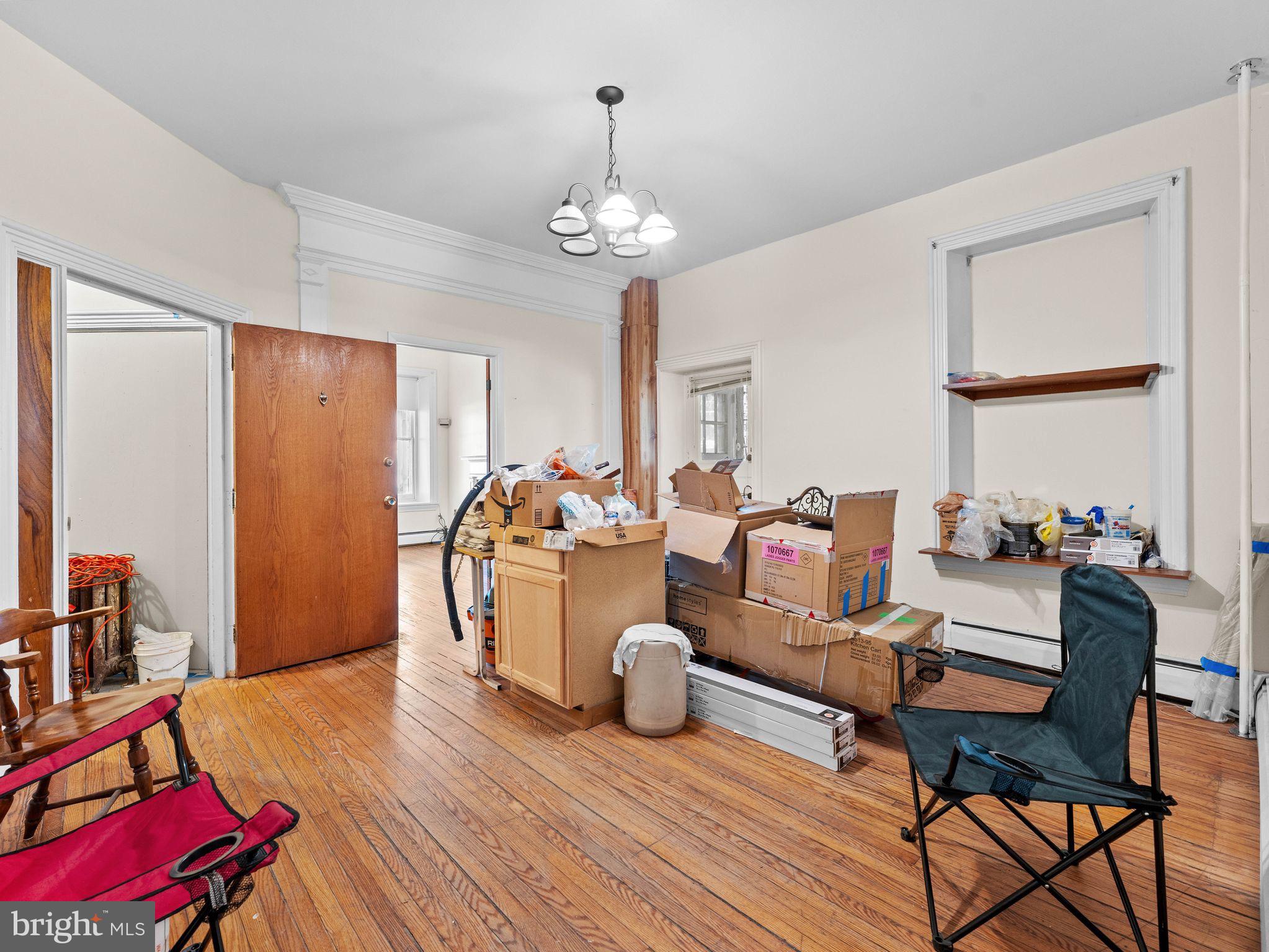 149 Herman Street Philadelphia, PA 19144 - Photo 21 of 35 a living room with furniture a chandelier and a dining table