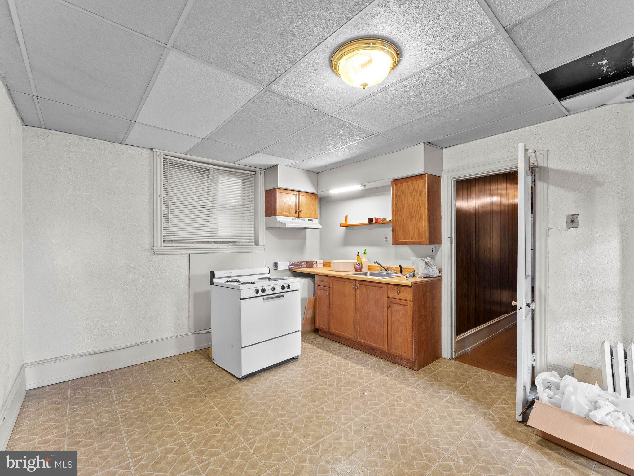 149 Herman Street Philadelphia, PA 19144 - Photo 8 of 35 a kitchen with a stove top oven and refrigerator