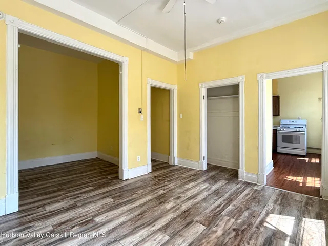 a view of a big room with wooden floor and bedroom view