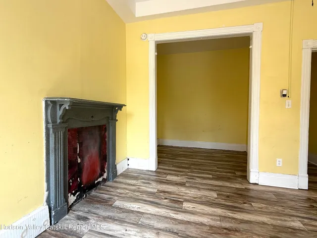 a view of a livingroom with wooden floor and a ceiling fan