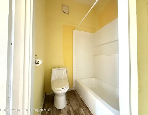 a bathroom with a toilet and a bathtub
