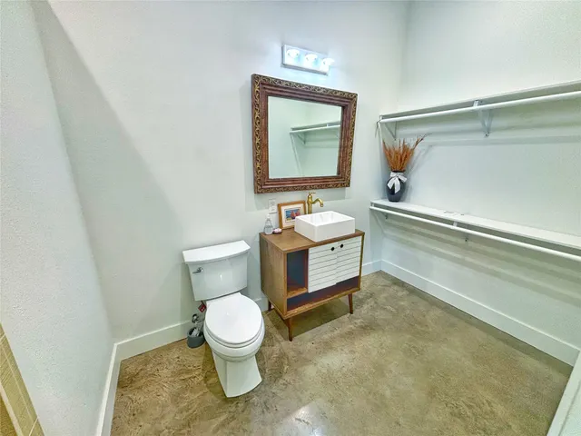 a bathroom with a toilet sink and shower