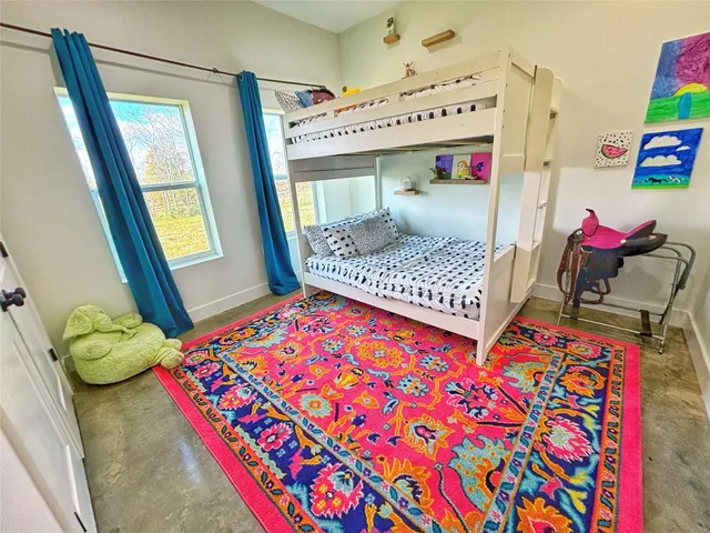 a spacious bathroom with a granite countertop sink a toilet and a mirror