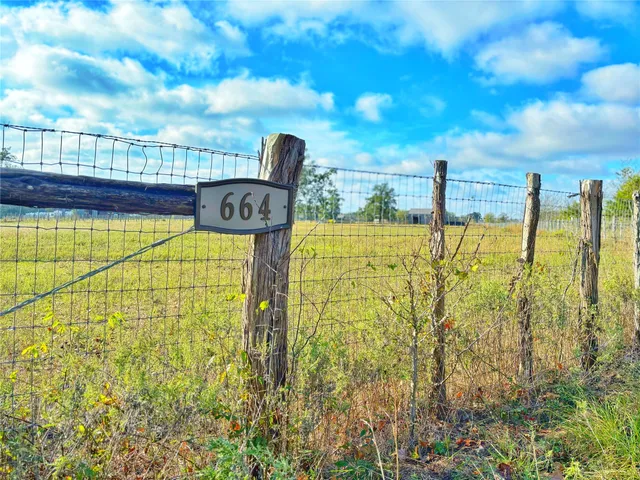 a view of a pool with an outdoor space and seating area