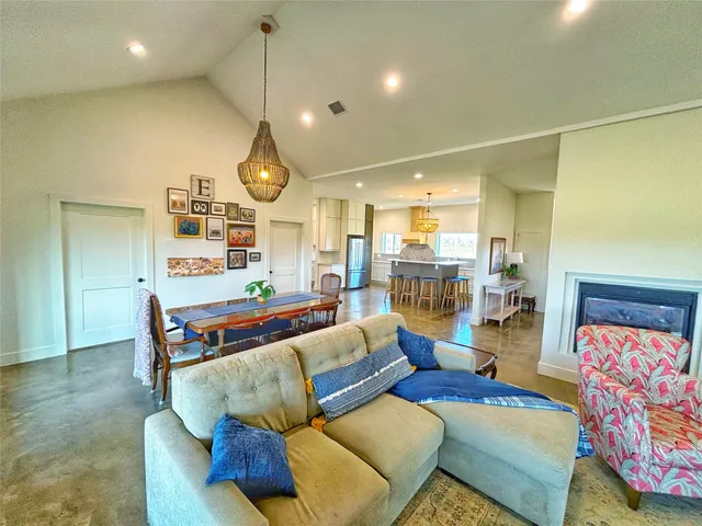 a living room with furniture and kitchen view