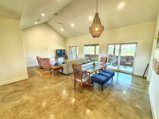 a view of a livingroom with furniture and a large window