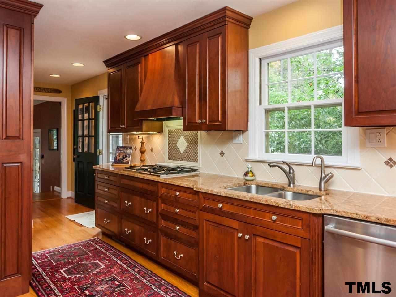 1804 Pony Run Road Raleigh, NC 27615 - Photo 10 of 25 Custom solid cherry cabinets, granite, top of line appliances including warming oven, gas oven and hot water dispenser. Kitchen