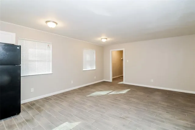 an empty room with windows and closet