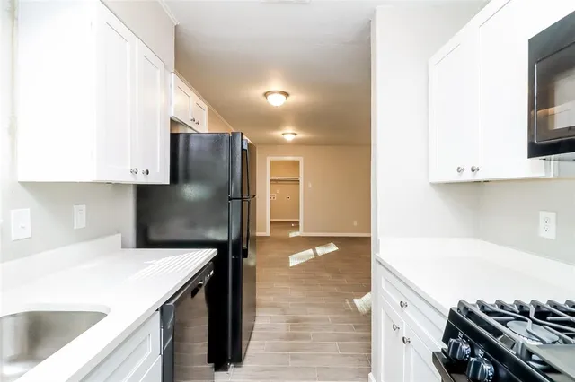a kitchen with a sink and a stove top oven